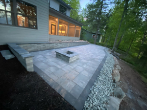 A square patio with a square fire pit in the middle.