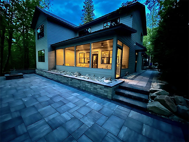 Paver patio connected to the side of a house