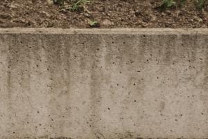 Close-up of poured concrete retaining wall.
